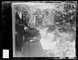 Sarah Jane Kirk with unidentified young man in garden