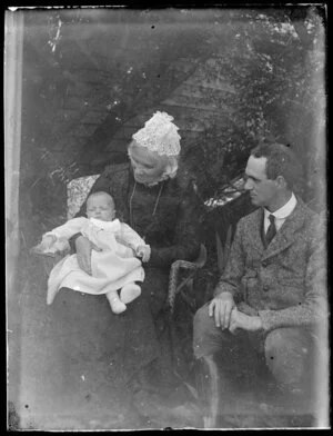 Sarah Jane Kirk holding a baby, Harry Borrer Kirk seated next to her