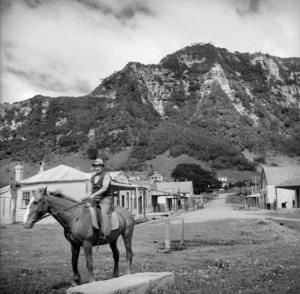 Man on a horse on the main street of Te Araroa, on the occasion of the hui for Te Moananui-a-kiwa Ngarimu