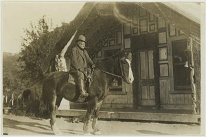 Man and horse outside Tanewai meeting house in Matahiwi