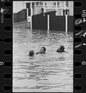 Three children swimming in flooded High Street, Taita - Photograph taken by Mark Coote