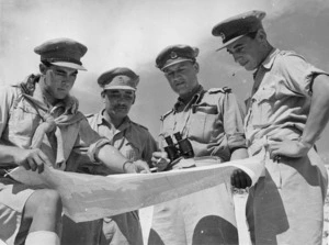 Elias, M D, fl 1943 (Photographer) : Behind the El Alamein front, officers of the 28th (Maori) Battalion, studying a map of the Western Desert