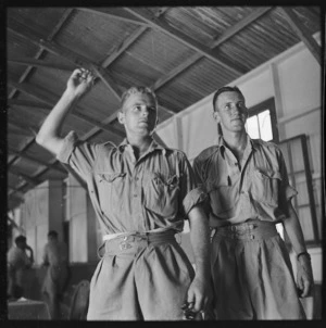 Two soldiers playing darts during World War II