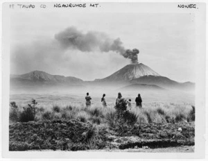 Mount Ngauruhoe emitting smoke, with group in foreground watching