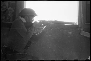 Private J Wyllie from 28 (Maori) Battalion sniping at the enemy in the Senio River area, Italy - Photograph taken by J Short