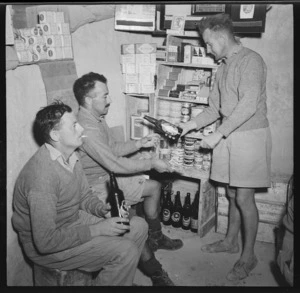 Soldiers buying beer in a dugout canteen during World War II