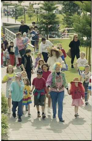 Author Margaret Mahy leads a group of children through Frank Kitts Park, Wellington - Photograph taken by Phil Reid
