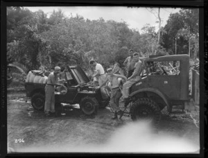 New Zealand soldiers draining water from a jeep that was hauled from a stream, Vella Lavella, Solomon Islands, during World War II