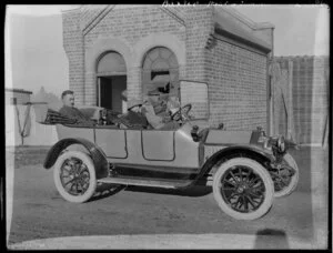 Buick 5-Passenger Touring motor car with unidentified passengers, outside Baxter Meal Company, Timaru