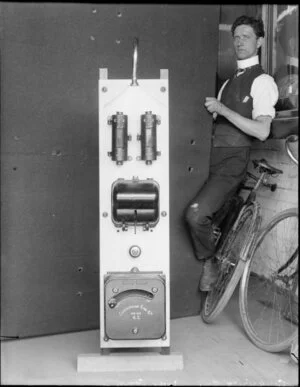 Canterbury Engineering Company equipment, perhaps a boiler, with a man apparently trying to fix it, and his bicycle