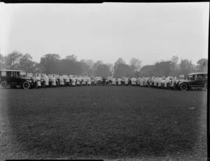 Motor cars from David Crozier Ltd, in a field, with drivers