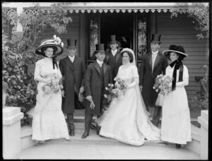 Wedding party, on steps outside a house