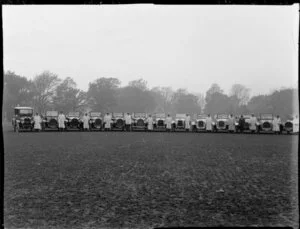 Motor cars from David Crozier Limited, motor car importers and engineers, arranged in a field, with drivers