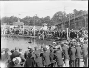 Two men fighting on slippery pole during Christchurch Exhibition, Christchurch