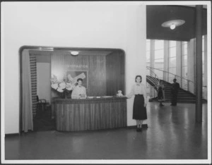 Women employees at an information counter, Centennial Exhibition, Wellington