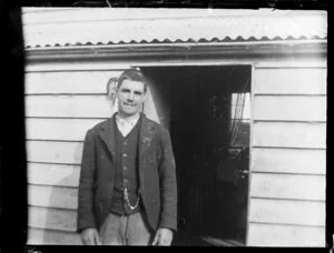 Man beside house doorway