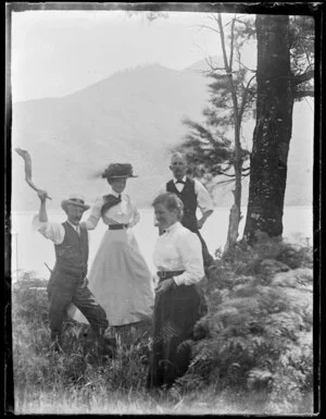 Amy Kirk, Alexander Scott Nicol, and two family members posing in a coastal or lake landscape