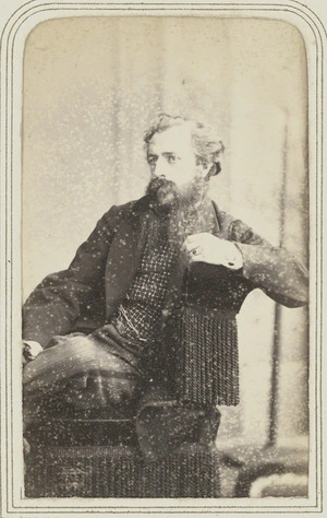 Man seated in tasselled chair