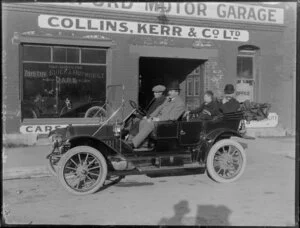 A Buick Model F Tourer, with unidentified passengers, outside Collins, Kerr & Company Ltd motor garage, Christchurch