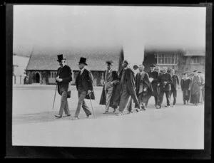 Schoolmasters and unidentified members of the clergy, walking in the grounds of Christ's College, Christchurch