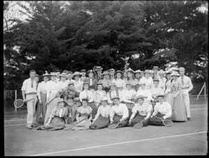 Men and women of a tennis club, with racquets