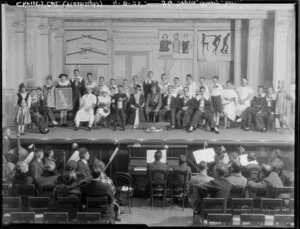 Students, including orchestra, in a theatrical production [Flashlight?] at Christ's College, Christchurch