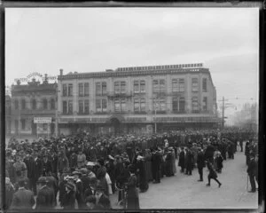 Returned soldiers wearing medals march past onlookers in Cathedral Square, Christchurch