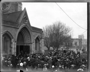 Soldiers filing into Christchurch Cathedral while a large crowd watches