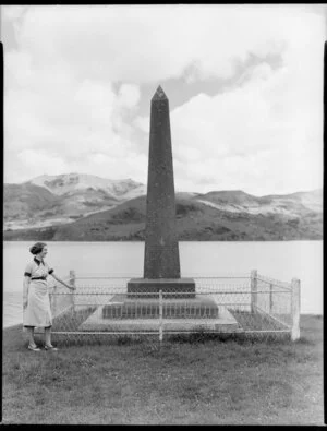 Unidentified woman standing next to Queen Victoria's 1898 diamond jubilee memorial monument, Akaroa, Christchurch
