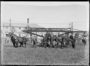 Unidentified fire brigade with large piece of equipment on wheels being towed by horses, possibly ladder