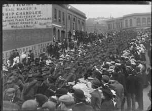 Crowds watching a procession of soldiers marching down [Princes Street?], Dunedin
