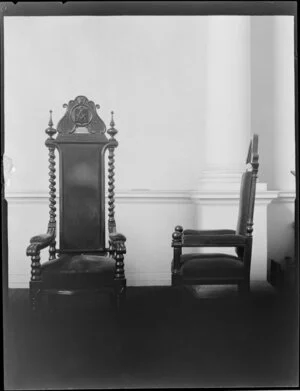 Two ornate leather chairs, one with the Masonic Lodge symbol carved on it, from Archibald Brothers, Christchurch