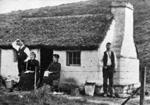 Group outside a cob cottage