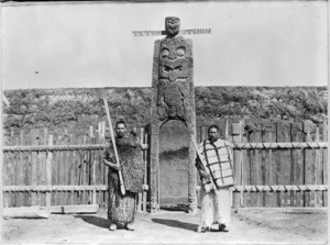Hurae Puketapu and Te Whenuanui, standing in front of the gateway at Mataatua Pa