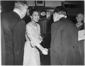 Queen of Thailand, Sirikit Kitiyakara, shaking hands with the leader of the NZBC orchestra, Vincent Aspey, in Wellington