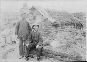 Reverend Alexander Don and an unidentified Chinese miner outside a sod house, Mitchells Flat, Otago