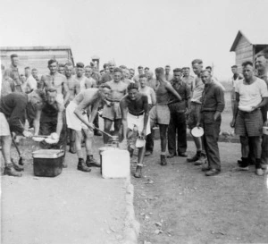 Prisoners of war at Camp 57, Gruppignano, Italy, lining up for food