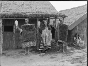 Te Rangikatukua, Maggie Papakura and Hekemaru Kaiawha standing outside Maori Pa constructed for Christchurch Exhibition