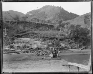 A man in a cage crossing the river near Fordell, Whanganui region
