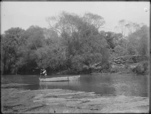 Man in a punt on a river, location unidentified