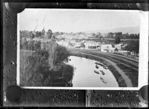 View of boats on a river in an unidentified town, possibly Christchurch, from an original photograph by Grand & Dunlop