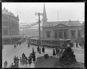 Long tram turning the corner in front of the Bank of New Zealand, Cathedral Square, Christchurch