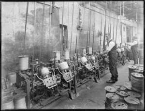 Interior of a twine spinning factory with machinery and reels of twine