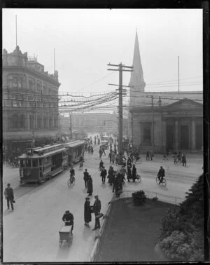 Scene in Christchurch, looking toward Cathedral Square, with the Bank of New Zealand building, a tram, cyclists and pedestrians in the foreground