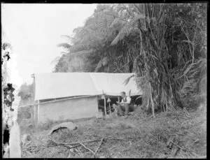 Man with a tent, camping near Mount Messenger