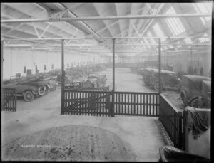 Interior of service station, with cars and caption 'Service Station, looking East'