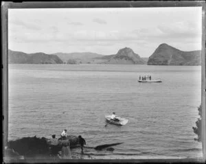 People in boats and paddling in the water, Whangaroa Harbour