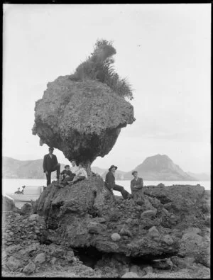 Coastal scene with a boating party and an unusual 'stalked' rock, probably Whangaroa Harbour