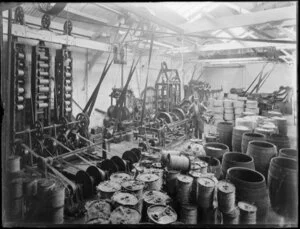 Interior of a twine spinning factory, with spindles, pulleys and spools of twine from New Zealand flax
