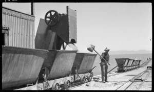 Man loading a railway truck at Golden Bay Cement Works, Tarakohe